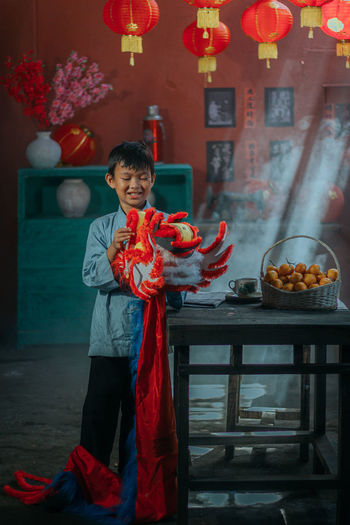 Rear view of man holding lion dance at home