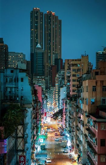 High angle view of road amidst buildings against sky at dusk