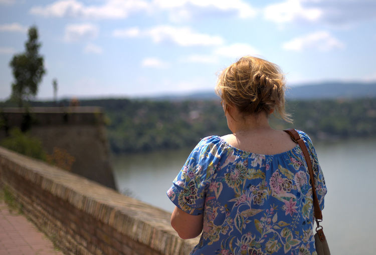Rear view of woman standing against sky