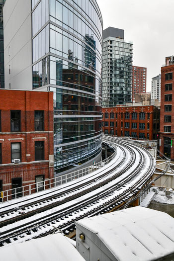 Urban elevated commuter train tracks through the city in winter
