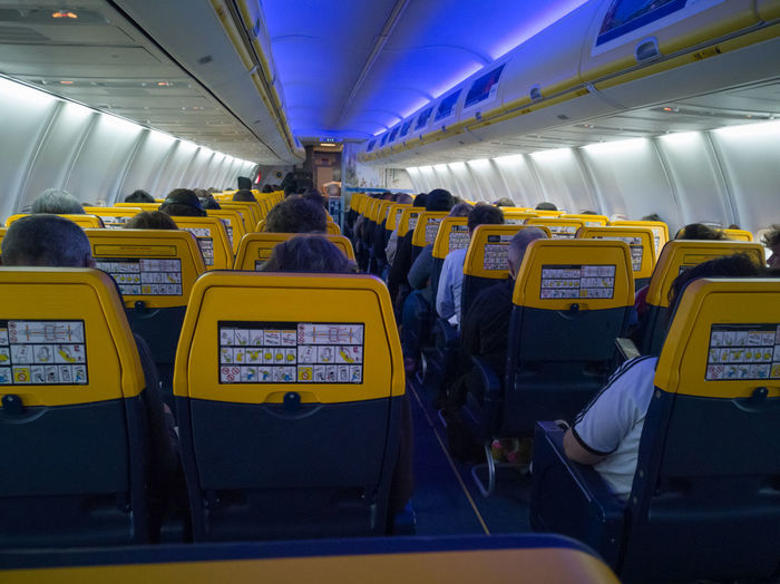 Rear view of people traveling in airplane