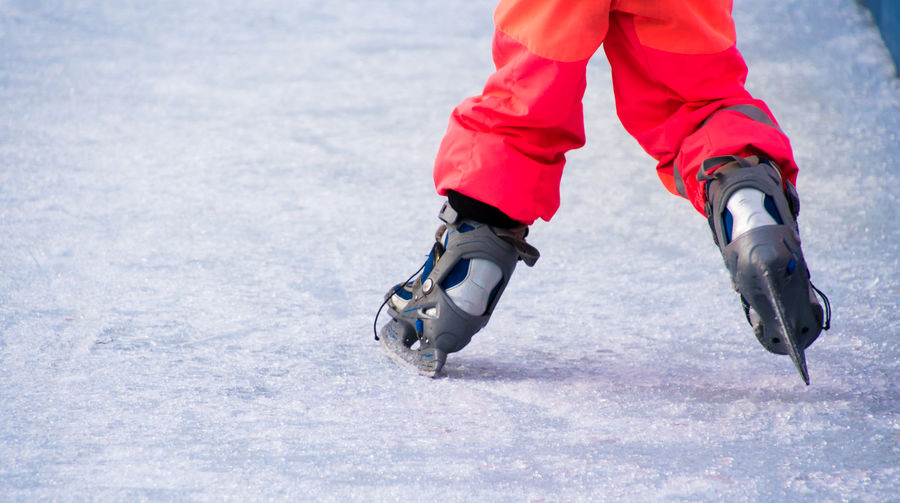 Low section of person skating on ice