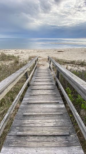 Wooden boardwalk leading towards sea at chatham, cape cod 