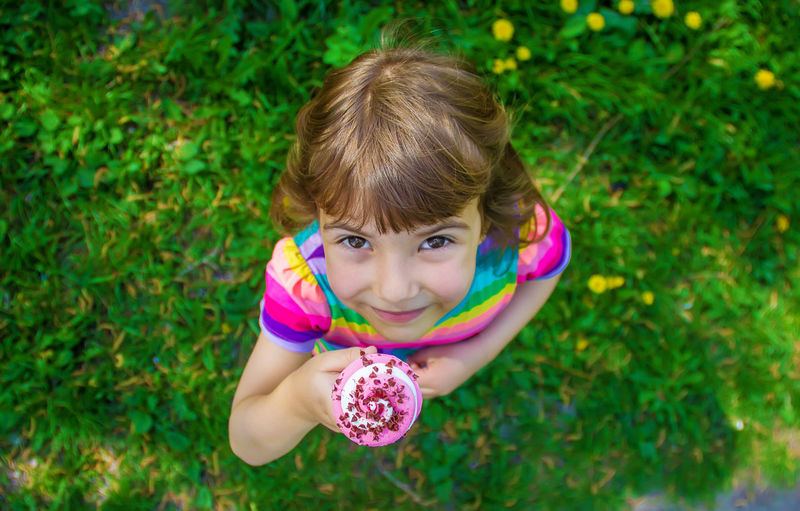 Portrait of cute girl playing with flowers