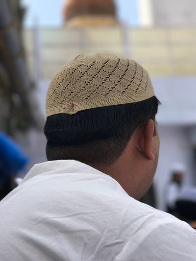 Rear view of man wearing skull cap
