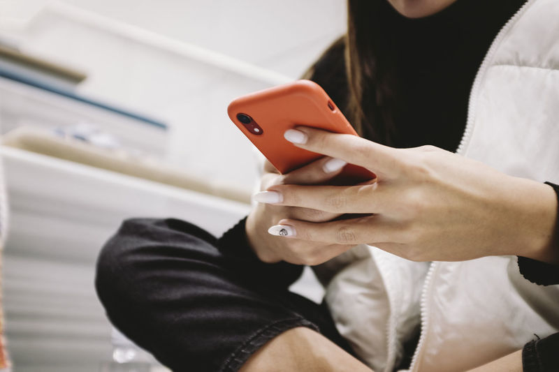 Midsection of man using mobile phone