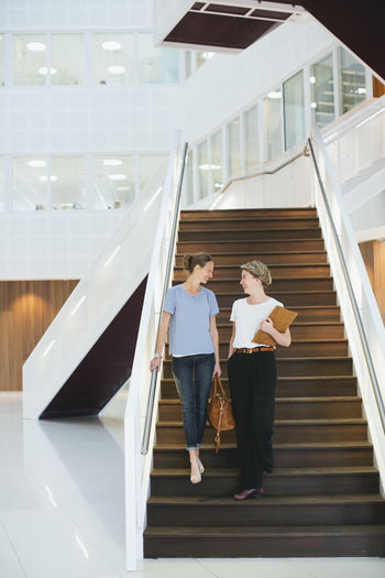 Young women in office building hall