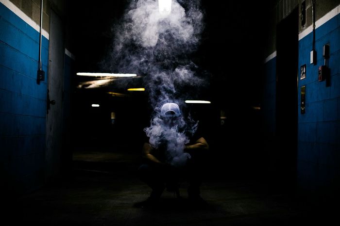 PORTRAIT OF MAN STANDING BY ILLUMINATED BUILDING