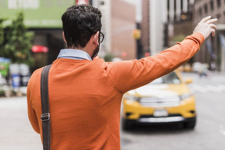 Usa, new york city, businessman hailing cab