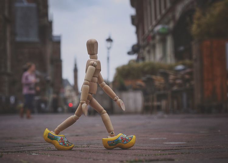 Close-up of figurine walking on footpath