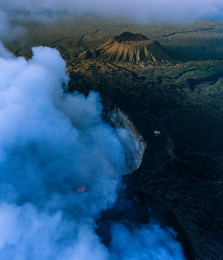 Aerial view of smoke emitting from volcanic mountain