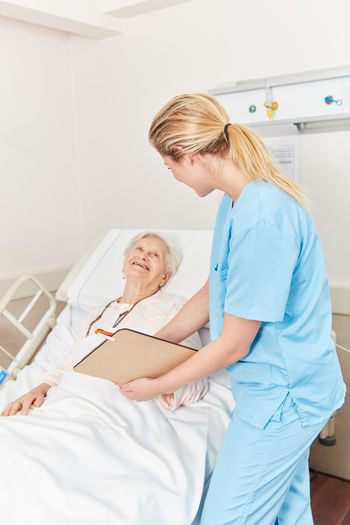 Nurse assisting woman at hospital