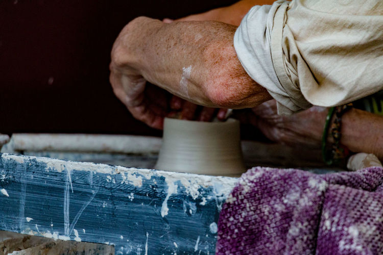 Close-up of man working on pottery wheel