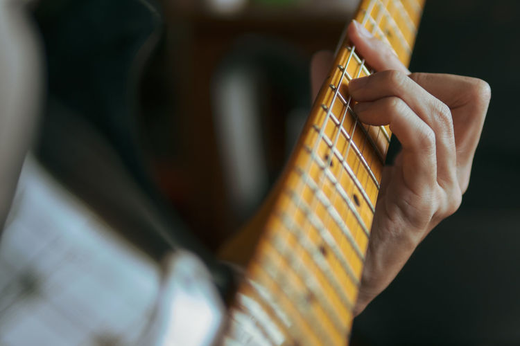 Close-up of hand playing guitar