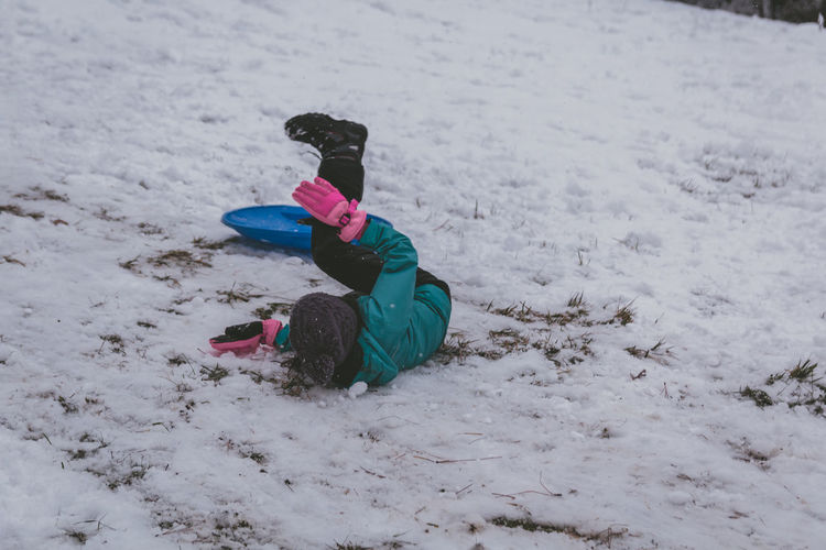High angle view of girl playing in snow