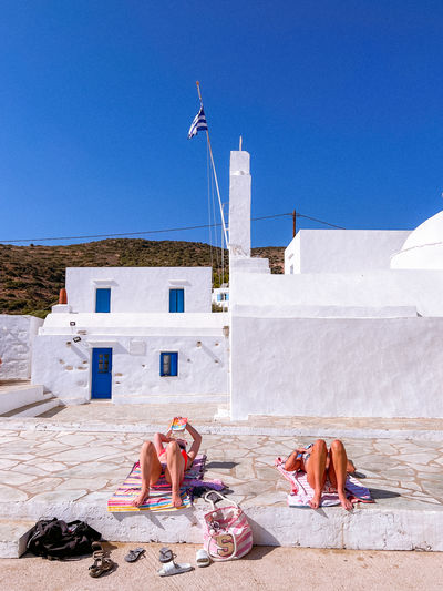 Sunbathers next to a church on the greek island of sifnos