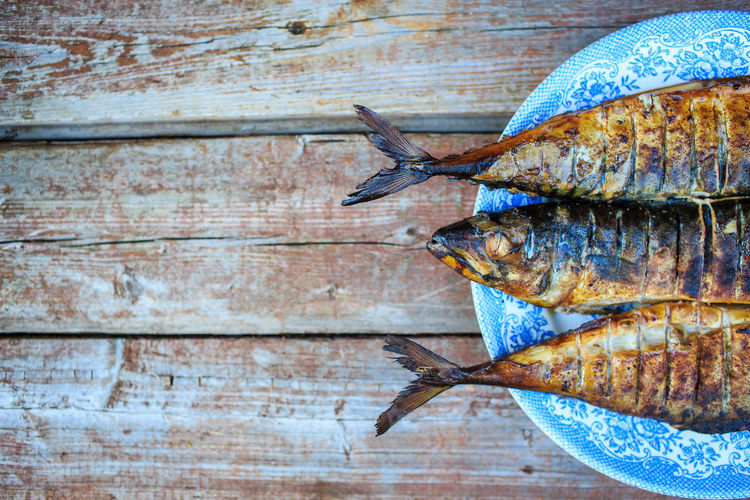 Grilled mackerel on blue plate