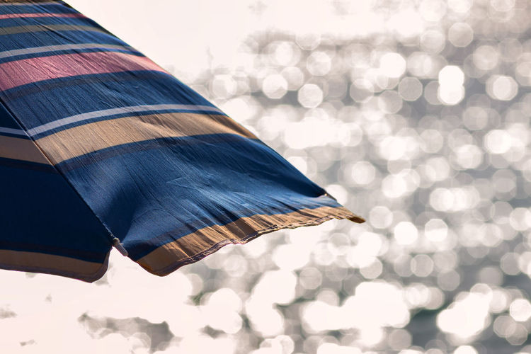 Cropped image of parasol against blurred background