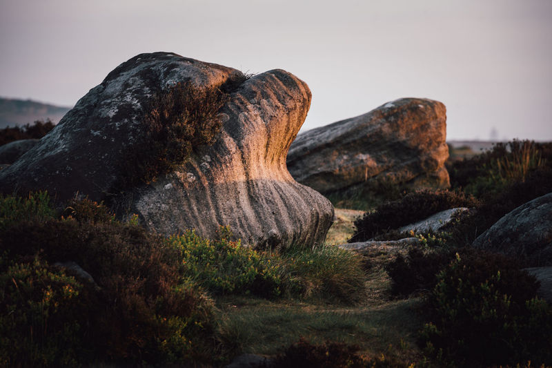 Rock formation on land against sky