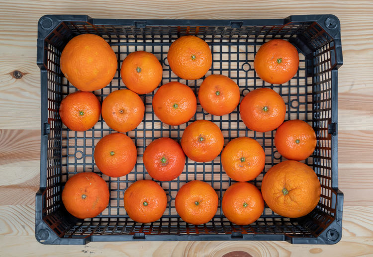 High angle view of orange fruits in basket