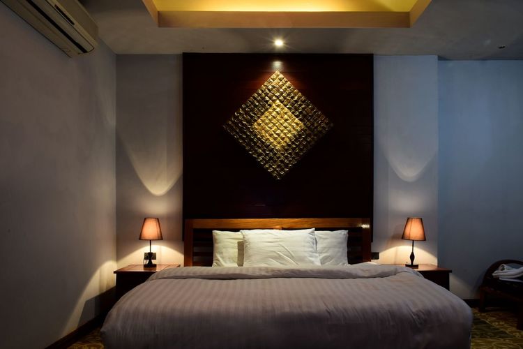 Illuminated interior of bedroom at home