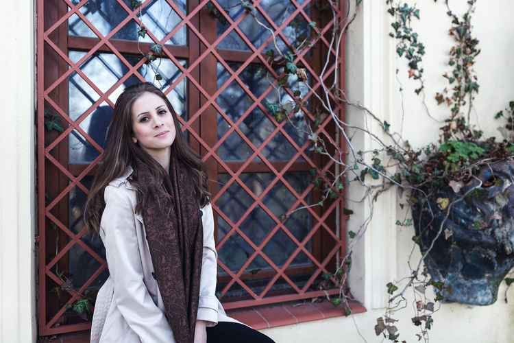 Beautiful girl in a beige coat on the street