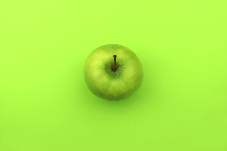 Close-up of apple against green background