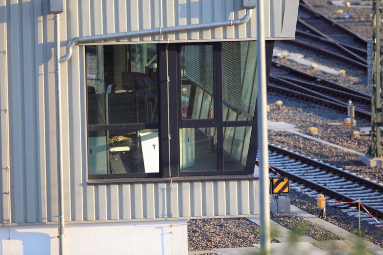 Railroad tracks seen through glass window of train