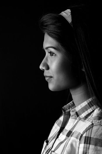 Young woman looking away in darkroom