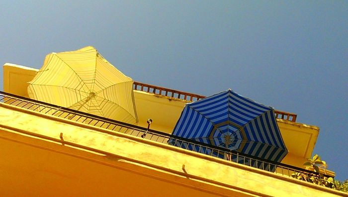 Low angle view of sun umbrellas on balcony