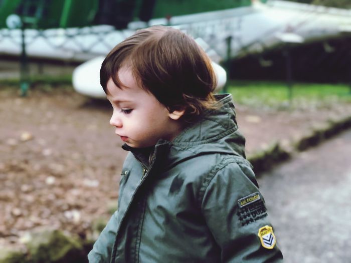 Portrait of cute boy standing outdoors