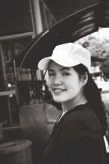 Portrait of smiling woman wearing cap