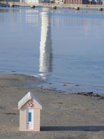 Model house on shore at beach