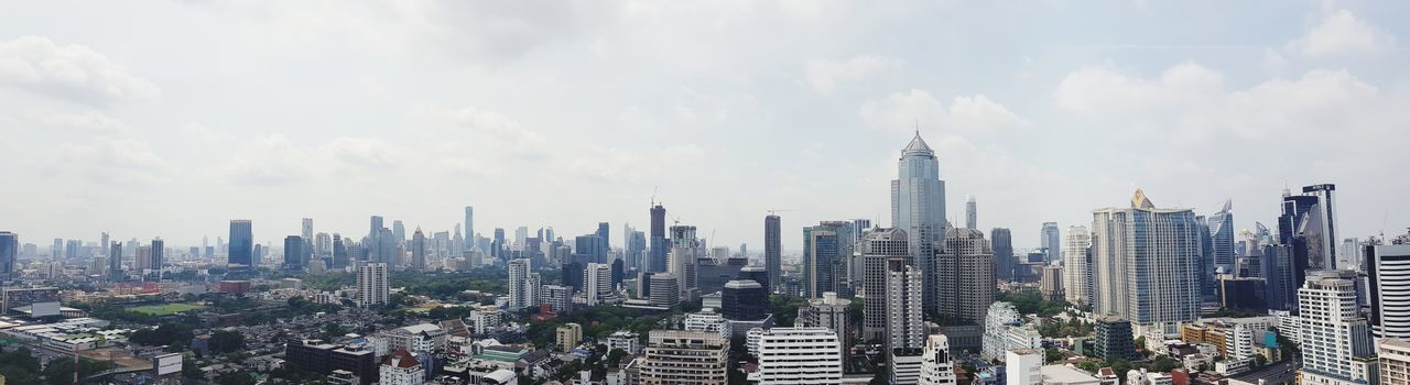 Panoramic view of modern buildings in city against sky