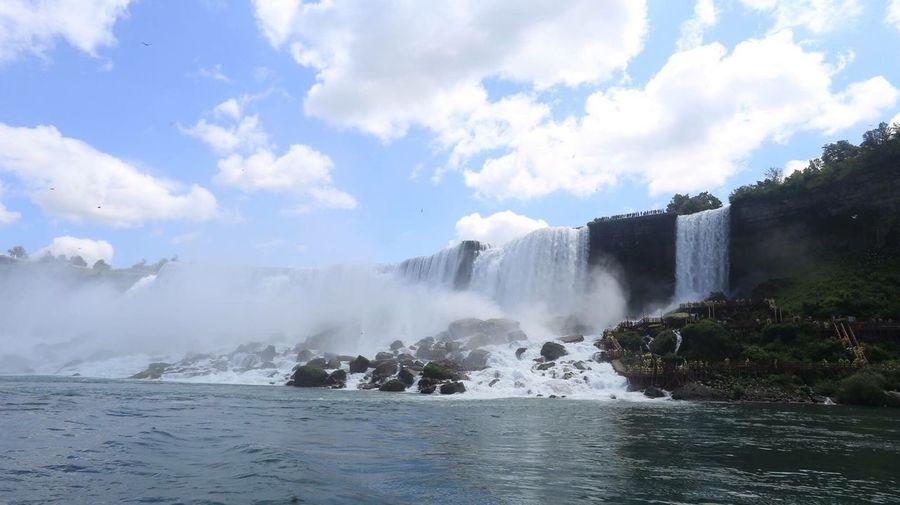 Scenic view of waterfall against sky
