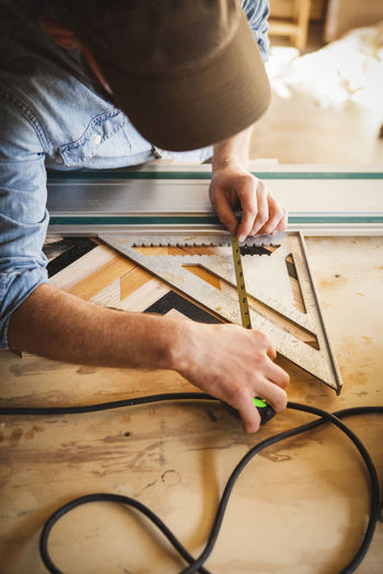 Midsection of man working on table