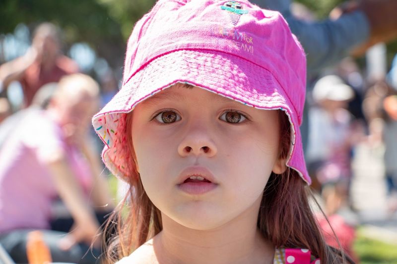 Close-up portrait of innocent girl wearing hat