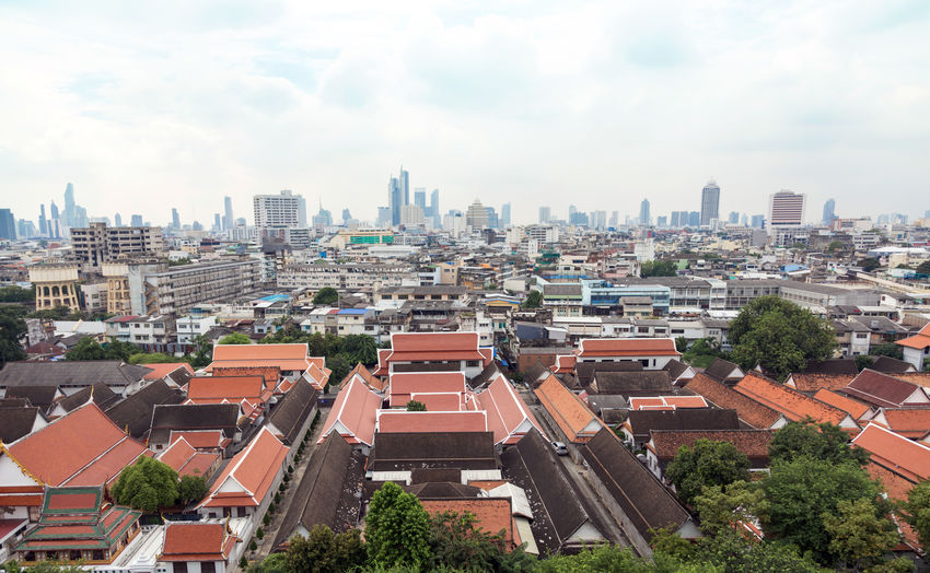 Landscape view of bangkok thailand with buddhism temple and urban city from top view