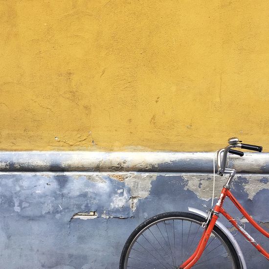 Close-up of bicycle parked against wall