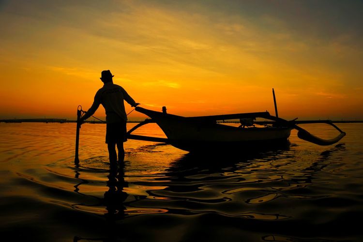 Silhouette of fisherman in bali