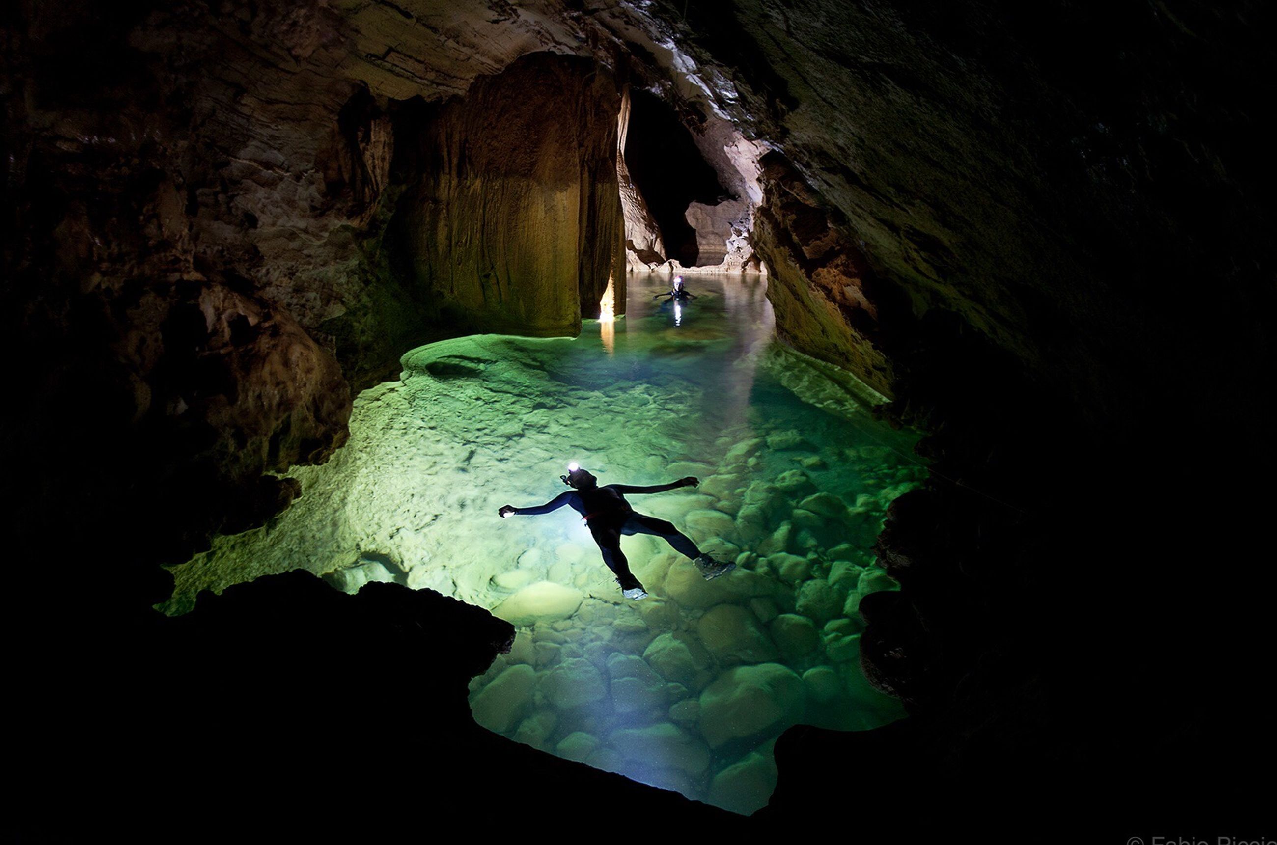 WOMAN SWIMMING IN CAVE