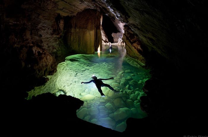 WOMAN SWIMMING IN CAVE