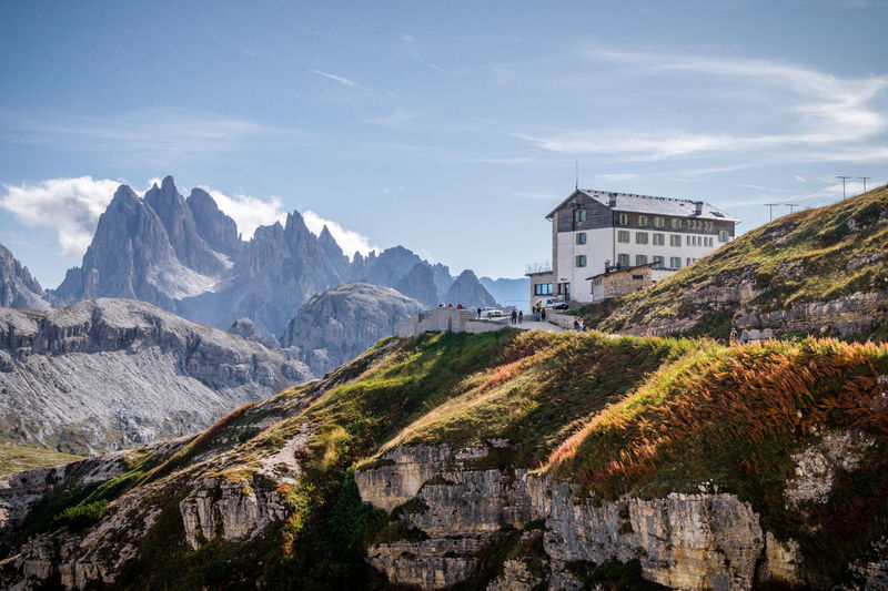 Scenic view of mountains and building against sky - cadini si misurina