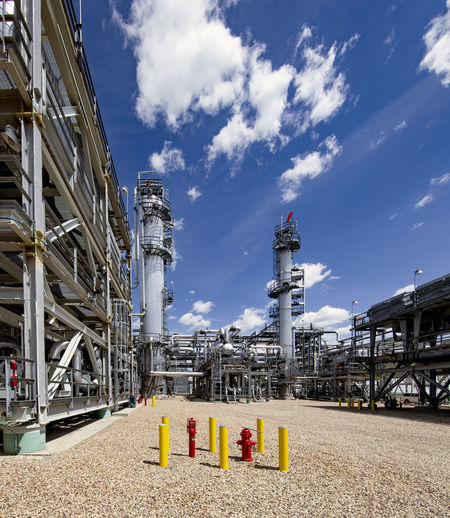 Natural gas plant structures against blue sky