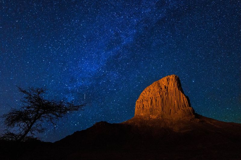 Rock formations against sky at night