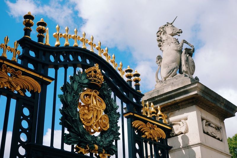 Low angle view of entrance gate against sky at buckingham palace