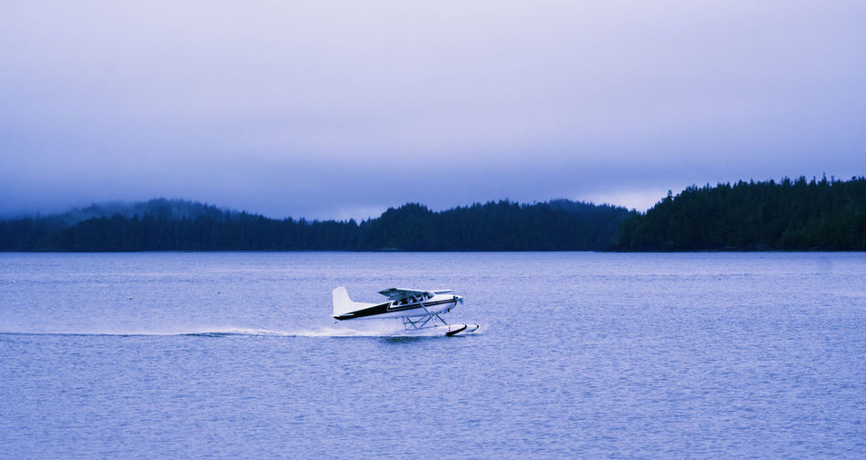 Airplane on sea against sky