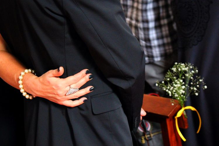 Cropped image of couple and man standing at church during wedding ceremony