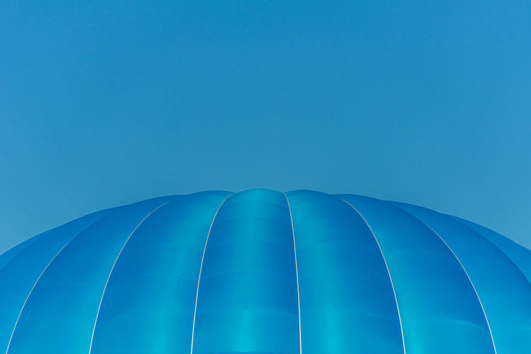 Low angle view of blue hot air balloon against blue sky