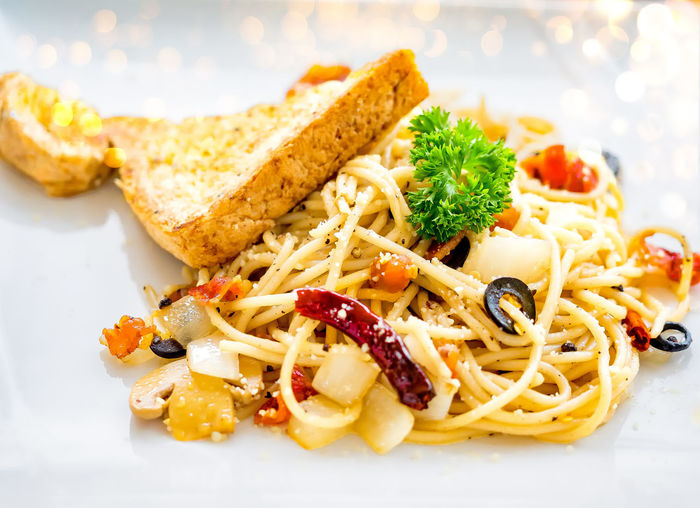 Delicious spaghetti with bacon and bread- italian food style.